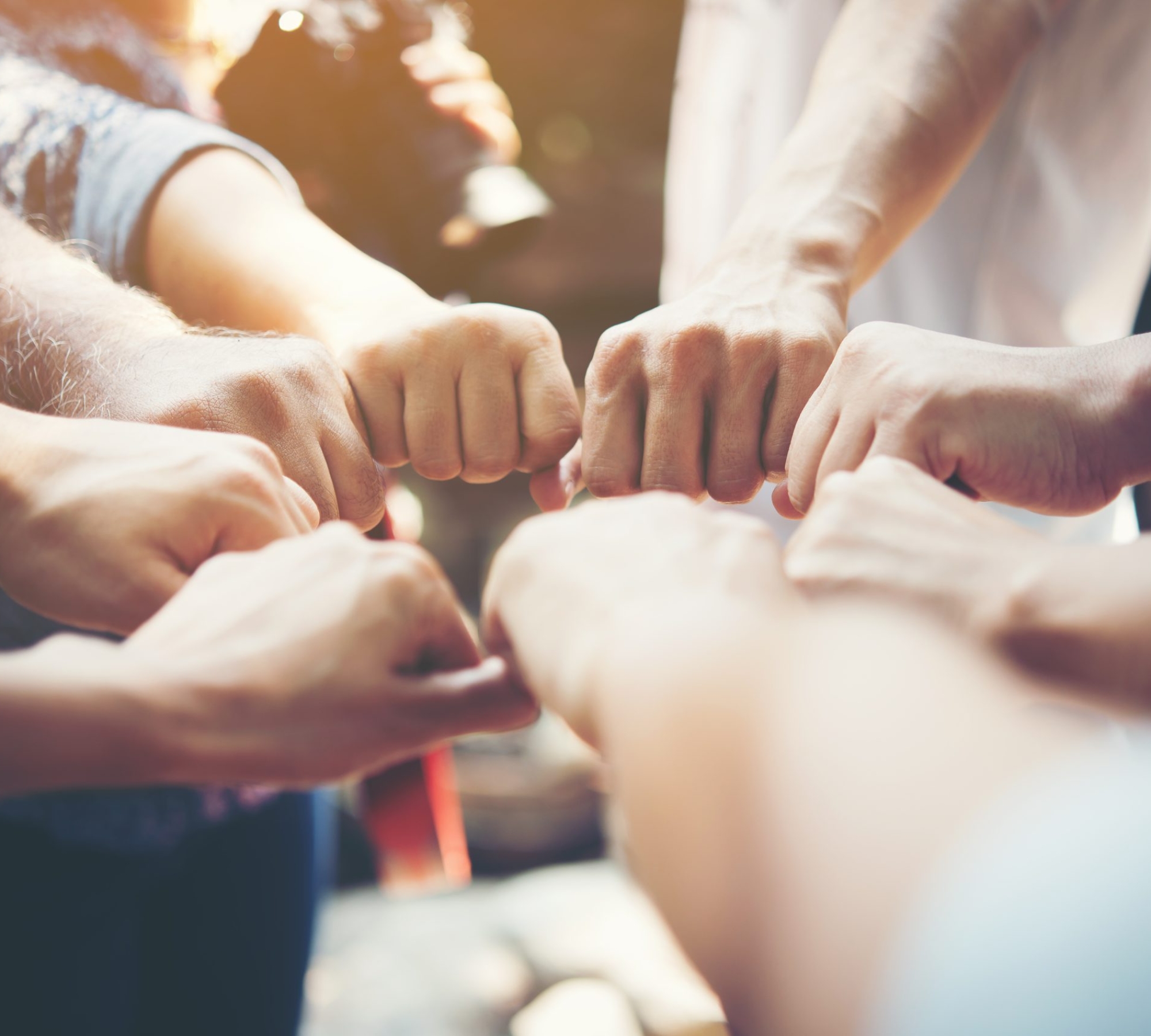 Close up of young people putting their hands together. Team with stack of hands showing unity and teamwork.